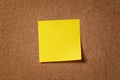 Yellow reminder sticky note on cork board Royalty Free Stock Photo