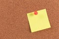 Yellow reminder sticky note on cork board Royalty Free Stock Photo