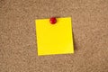 Yellow reminder sticky note on cork board, empty space for text Royalty Free Stock Photo