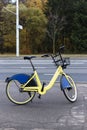 Yellow rental bike stands near the road