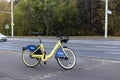 Yellow rental bike stands near the road