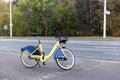 Yellow rental bike stands near the road