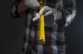 Yellow retractable tape measure tool in hands of man in shirt, closeup Royalty Free Stock Photo