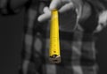 Yellow retractable tape measure tool spread to camera in male hands in white gloves, closeup Royalty Free Stock Photo