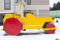 Yellow retro road roller at the winter landscape. Royalty Free Stock Photo