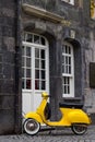 A yellow retro style model scooter in Essen.