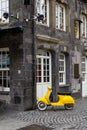 Yellow retro style scooter parked.