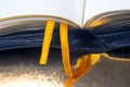 Yellow ribbon bookmark for a book. Open bible. The study of literature Royalty Free Stock Photo