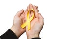 Yellow ribbon in hands, symbol Bladder cancer, Sarcoma, Bone can