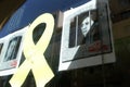 Yellow ribbon next to pictures of the catalan politics in jail since 2017 seen in Barcelona