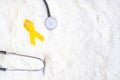 Yellow Ribbon and Stethoscope on white background for supporting people living and illness. September Suicide prevention day, Royalty Free Stock Photo