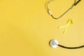 Yellow Ribbon and Stethoscope on yellow background for supporting people living and illness. September Suicide prevention day, Royalty Free Stock Photo