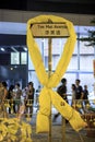 Yellow ribbon tied at the road sign