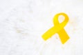 Yellow Ribbon on white background for supporting people living and illness. September Suicide prevention day, Sarcoma cancer and Royalty Free Stock Photo