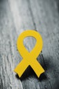 Yellow ribbon on a wooden surface