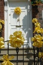 Yellow ribbons on white door Royalty Free Stock Photo