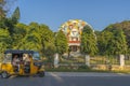 Yellow rickshaw taxis on a road in Puttaparthi village.