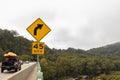 A yellow right curve ahead traffic sign on Sandy Hook bridge over Potomac River. Royalty Free Stock Photo