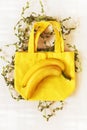 Yellow ripe bananas on a yellow cotton bag with leaves on a white background