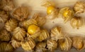 Yellow ripe Cape gooseberry fruit in a brown wooden box know as goldenberry or physalis, top view image Royalty Free Stock Photo
