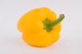 Yellow ripe shiny paprika bell pepper isolated on white.