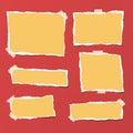 Yellow ripped strips, notebook, note paper for text or message stuck with sticky tape on bright red background.