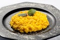 Yellow risotto rice garnished with carrot and mint