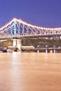 Yellow river and a bridge with lights at night Royalty Free Stock Photo