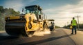 Road Roller Compressing Asphalt with Construction Worker Overseeing Royalty Free Stock Photo