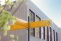 Yellow road sign or blank road signs showing direction against a building Royalty Free Stock Photo