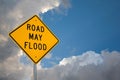 Road May Flood Sign Against A Blue Sky and Storm clouds. Royalty Free Stock Photo
