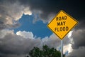 Road May Flood Sign Against Storm Clouds and A Tree.