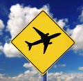 Yellow road sign with cloudscape and airplanes pictogram