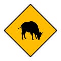 Yellow road sign: Cow Crossing Zone. warning signal. Drive slowly for animal safety. Royalty Free Stock Photo