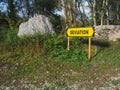 Yellow road sign with a directional arrow and the words \