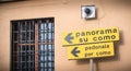 Yellow road sign indicating in Italian the direction of the Panorma of Como Royalty Free Stock Photo