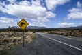 Yellow road sign with kiwi bird crossing by the road. Mountains in the background. Located in the Tongariro National Park, North Royalty Free Stock Photo