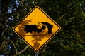 Yellow road sign with a truck and bridge symbol, caution to tall vehicles, low clearance Royalty Free Stock Photo