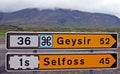 Yellow road signs showing direction and distance to Geysir and town Selfoss - Iceland