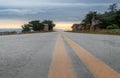 Yellow road stipes and blue sky Royalty Free Stock Photo