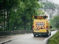 Yellow roadworks safety van driving fast Choranche