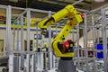 Yellow Robotic Arm in High-Tech Factory Setting