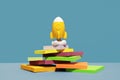 Yellow rocket stands on desk and blue background Royalty Free Stock Photo