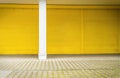Yellow roller shutter and pavement Royalty Free Stock Photo