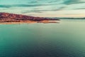 Yellow rolling hill and lake coastline at sunset. Royalty Free Stock Photo