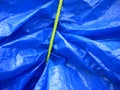 Yellow rope on blue tarpaulin Royalty Free Stock Photo