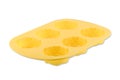 Yellow rose silicone cupcake or muffin form isolated on white background. Cake cup, silicone mold, bakeware.