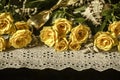 Yellow roses,dry branches of white gypsophila,reeds on white lace border with beads pearls on black background