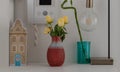 Yellow roses in Red ceramic vase, Lucky bamboo, Intercom handset Door entry, Light bulb and tin music box. Home decor