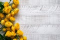 Yellow roses on the white wooden background. Royalty Free Stock Photo